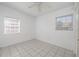 A bedroom with tile floors, white walls, and a ceiling fan at 1814 Leroy Dr, Haines City, FL 33844
