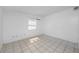 Neutral bedroom with tiled floor, a window for natural light, and ample open space at 1814 Leroy Dr, Haines City, FL 33844