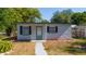 Inviting single-story home with black shutters, a covered entry, and a welcoming pathway at 1814 Leroy Dr, Haines City, FL 33844