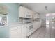 Well-lit kitchen showcasing white cabinetry, mosaic backsplash, and modern appliances at 1814 Leroy Dr, Haines City, FL 33844