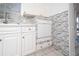 Clean kitchen with white cabinets, tile backsplash, and bright lighting under the window at 1814 Leroy Dr, Haines City, FL 33844