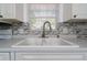 The kitchen features a stainless steel faucet and double basin sink with a window view at 1814 Leroy Dr, Haines City, FL 33844