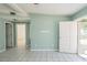 Spacious living room with tiled floors, multiple entryways, and bright natural light at 1814 Leroy Dr, Haines City, FL 33844