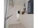 Functional utility space with water heater, shelves, and tiled flooring for practicality at 1814 Leroy Dr, Haines City, FL 33844