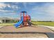 Community playground featuring a colorful play structure with slides at 187 Flag Lilly Ln, Umatilla, FL 32784