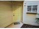 Close-up of the front door with visible unit number; a welcoming entrance with a nice rug and small window at 1948 Lake Atriums Cir # 115, Orlando, FL 32839