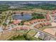 Scenic aerial view of a Primary-planned community featuring a lake, clubhouse, pools, and homes with private pools at 209 Rosso Dr, Davenport, FL 33837