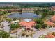 Community clubhouse with pool and playground sits on a lake, perfect for relaxation and recreation at 209 Rosso Dr, Davenport, FL 33837