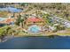 Community clubhouse with pool and playground sits on a lake, perfect for relaxation and recreation at 209 Rosso Dr, Davenport, FL 33837