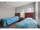Bedroom with a pair of twin beds and nightstand with stylish comforters at 209 Rosso Dr, Davenport, FL 33837