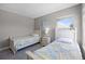 Bedroom featuring two twin beds with grey, yellow, and white bedding and a window at 209 Rosso Dr, Davenport, FL 33837