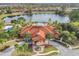 Aerial view of the clubhouse, showcasing the large building, fountain and palm trees at 209 Rosso Dr, Davenport, FL 33837