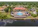 Beautiful aerial view of a community pool, seating areas, and lake, perfect for relaxation at 209 Rosso Dr, Davenport, FL 33837