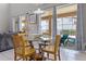 Dining area featuring a glass table, wooden chairs, and sliding doors to outdoor patio space at 209 Rosso Dr, Davenport, FL 33837