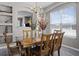 Dining room showcasing wood furniture, a chandelier and ample natural light from a large window at 209 Rosso Dr, Davenport, FL 33837