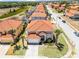 Charming two-story home with a red tile roof, attached garage and tropical landscaping in a sunny neighborhood at 209 Rosso Dr, Davenport, FL 33837