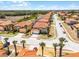Charming two-story home with a red tile roof, attached garage and tropical landscaping in a sunny neighborhood at 209 Rosso Dr, Davenport, FL 33837