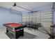 Recreational garage featuring a pool table, ping pong table and glass table under a blue ceiling at 209 Rosso Dr, Davenport, FL 33837