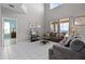 Open-concept living room with tall ceilings, tile floors, and view of the outdoor area at 209 Rosso Dr, Davenport, FL 33837