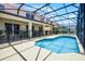 Backyard fenced pool area with a covered patio and sun shade overlooking a pristine blue pool at 209 Rosso Dr, Davenport, FL 33837