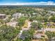 This aerial view showcases the home's location amongst mature trees and nearby buildings at 217 W Bay St, Winter Garden, FL 34787