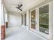 Covered patio area with ceiling fans and access through elegant glass doors at 217 W Bay St, Winter Garden, FL 34787