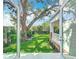 View of landscaped backyard and covered porch from inside the home at 217 W Bay St, Winter Garden, FL 34787