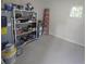 Basement with a water heater, shelves with tools and a ladder at 217 W Bay St, Winter Garden, FL 34787