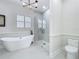 Bright bathroom with a freestanding tub, glass enclosed shower, and modern fixtures at 217 W Bay St, Winter Garden, FL 34787