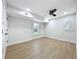 Bright bedroom features hardwood flooring, plantation shutters on the windows, and modern ceiling fan at 217 W Bay St, Winter Garden, FL 34787
