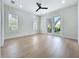 Bedroom with light hardwood floors and glass doors with backyard view at 217 W Bay St, Winter Garden, FL 34787