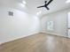 Vaulted bedroom with hardwood floors, a ceiling fan, and natural light from the window at 217 W Bay St, Winter Garden, FL 34787