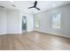 Spacious bedroom with light hardwood floors and ensuite bathroom at 217 W Bay St, Winter Garden, FL 34787