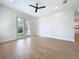 Bedroom features light hardwood floors and glass doors leading to backyard at 217 W Bay St, Winter Garden, FL 34787