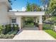 View of the home's exterior featuring a large carport with brick columns at 217 W Bay St, Winter Garden, FL 34787