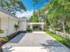Side view of the property showing a gravel driveway and manicured landscaping at 217 W Bay St, Winter Garden, FL 34787