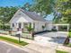 Attractive home boasting a carport, gravel driveway, and a neatly maintained lawn with lush landscaping at 217 W Bay St, Winter Garden, FL 34787