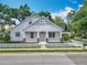 Inviting home exterior with a manicured lawn, white picket fence, and charming front porch at 217 W Bay St, Winter Garden, FL 34787