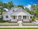 Charming home featuring a white picket fence, covered porch, and a beautifully landscaped front yard at 217 W Bay St, Winter Garden, FL 34787