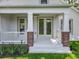 Charming front porch with brick accents and multiple glass door entrances, enhancing curb appeal at 217 W Bay St, Winter Garden, FL 34787