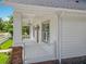 Inviting front porch with classic white railings and stylish outdoor lighting at 217 W Bay St, Winter Garden, FL 34787