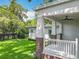 Charming front porch with brick accents, white columns, and a ceiling fan, perfect for relaxing outdoors at 217 W Bay St, Winter Garden, FL 34787