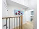 Upstairs hallway features wood floors and a modern painting, leading to other areas of the home at 217 W Bay St, Winter Garden, FL 34787