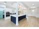 Open kitchen featuring a large island, stainless steel appliances, and a view to the dining area at 217 W Bay St, Winter Garden, FL 34787