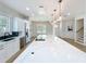 Bright kitchen featuring a large island with marble countertops, and stainless steel appliances at 217 W Bay St, Winter Garden, FL 34787