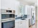 Well-appointed kitchen boasting stainless steel appliances, sleek countertops, and modern fixtures at 217 W Bay St, Winter Garden, FL 34787