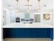 Spacious kitchen with a large island, white countertops, modern lighting, and stainless steel appliances at 217 W Bay St, Winter Garden, FL 34787