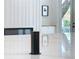 Modern kitchen with a pop-up power outlet and a view of the sleek fireplace in the next room at 217 W Bay St, Winter Garden, FL 34787