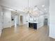 Spacious living room with a large island, modern chandelier, stainless steel appliances and an open layout at 217 W Bay St, Winter Garden, FL 34787