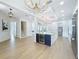 Spacious living room with a large island, modern chandelier, stainless steel appliances and an open layout at 217 W Bay St, Winter Garden, FL 34787